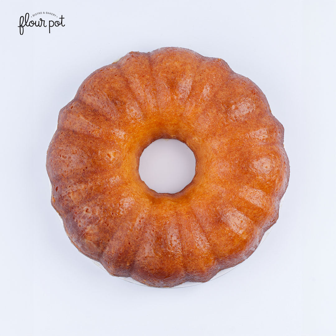 Golden Bundt-style passionfruit rum cake with a glossy finish