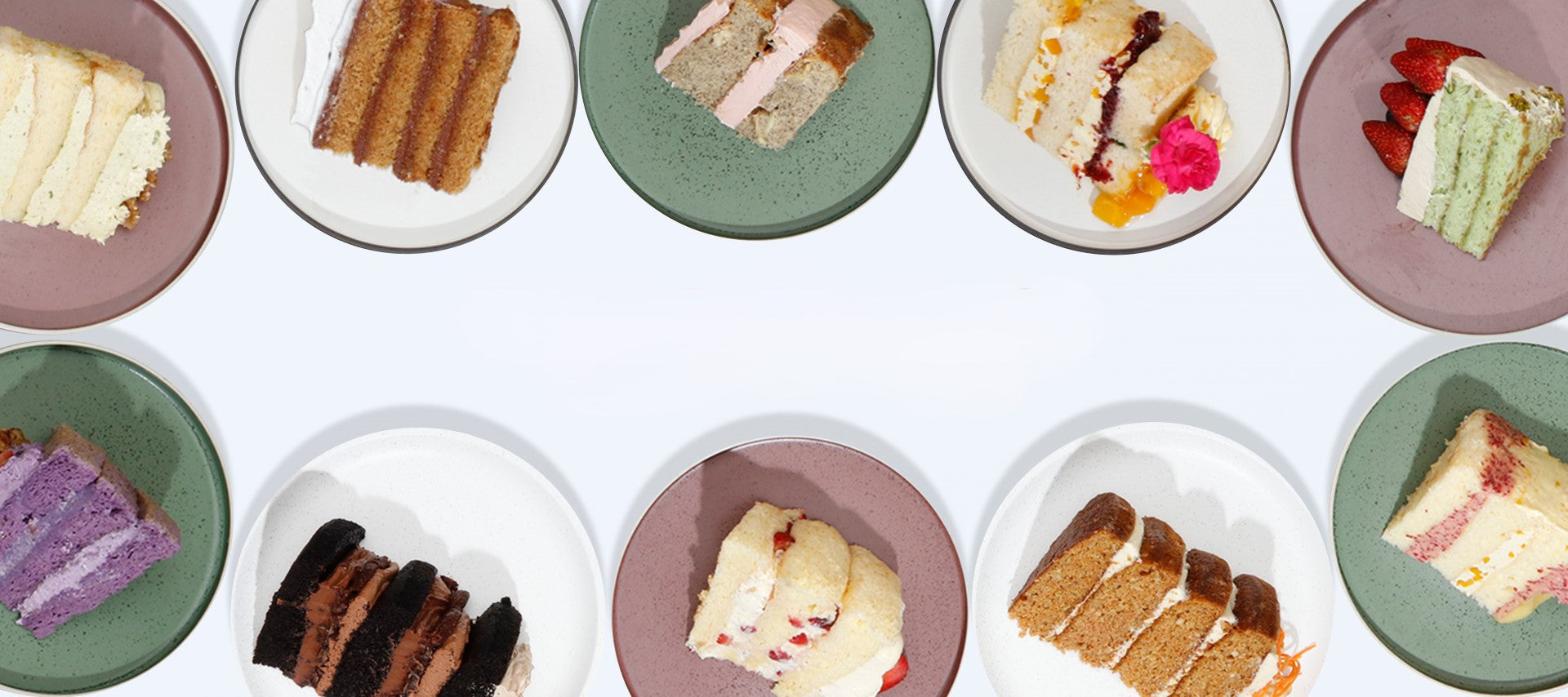 Assorted slices of artisan cakes in various flavors, displayed on colorful plates 